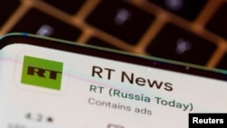 Приложение RT News (Russia Today) на смартфоне. Архивный коллаж